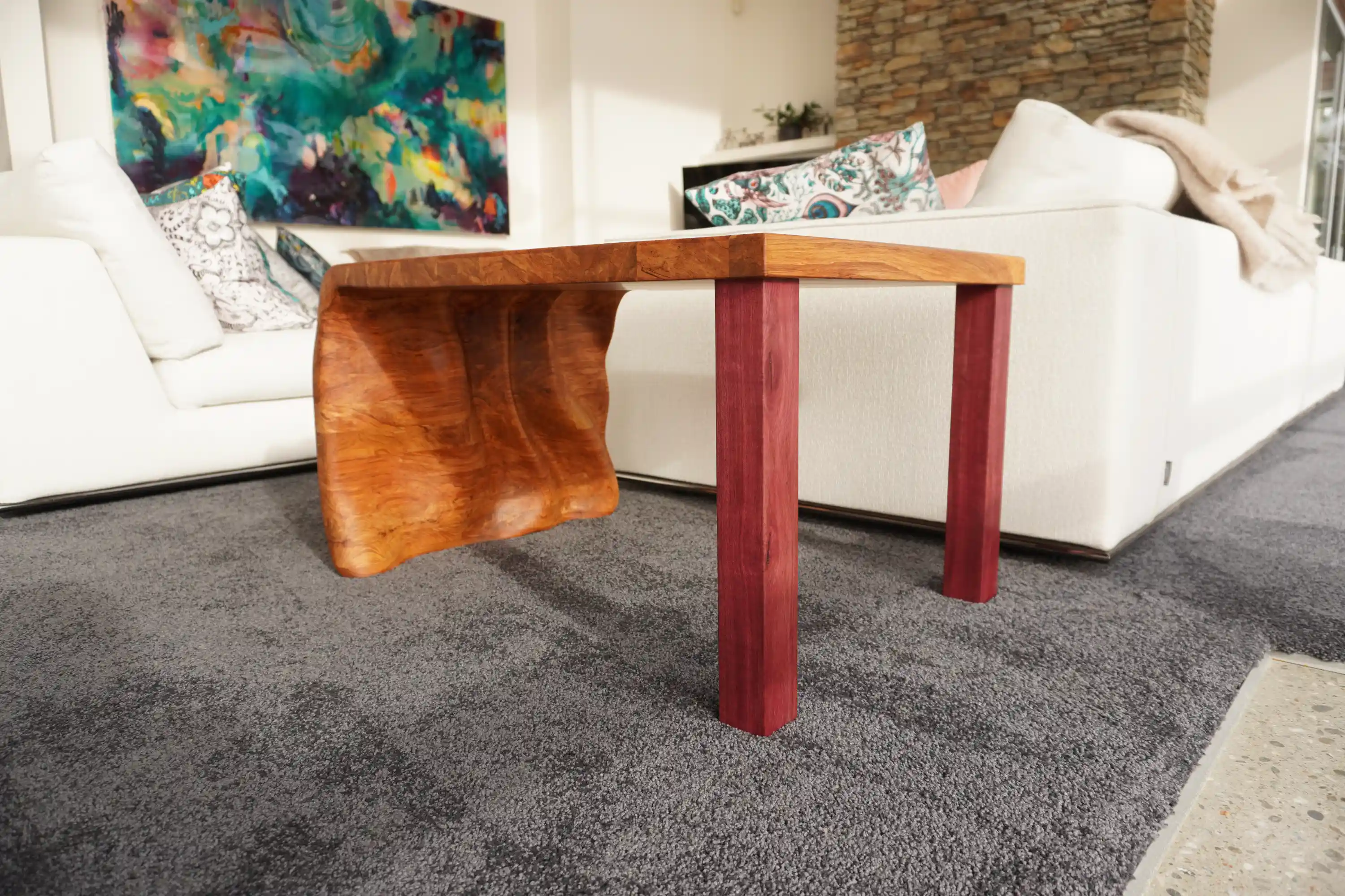 Purpleheart legs joined to Rimu timber tabletop with detailed wood joinery