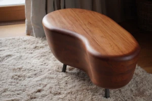 Graceful Embrace solid timber coffee table beside fireplace