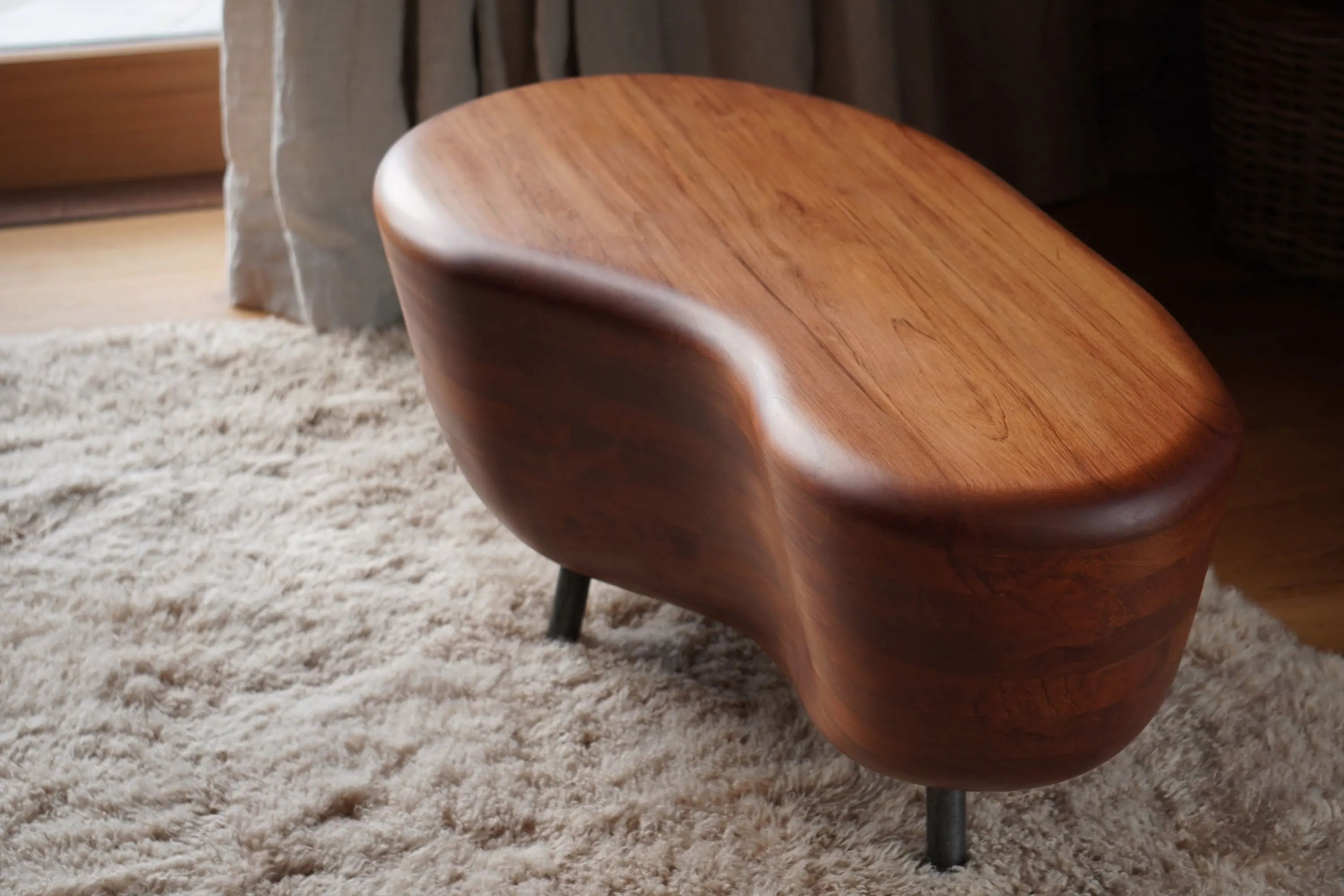 Graceful Embrace solid timber coffee table beside fireplace