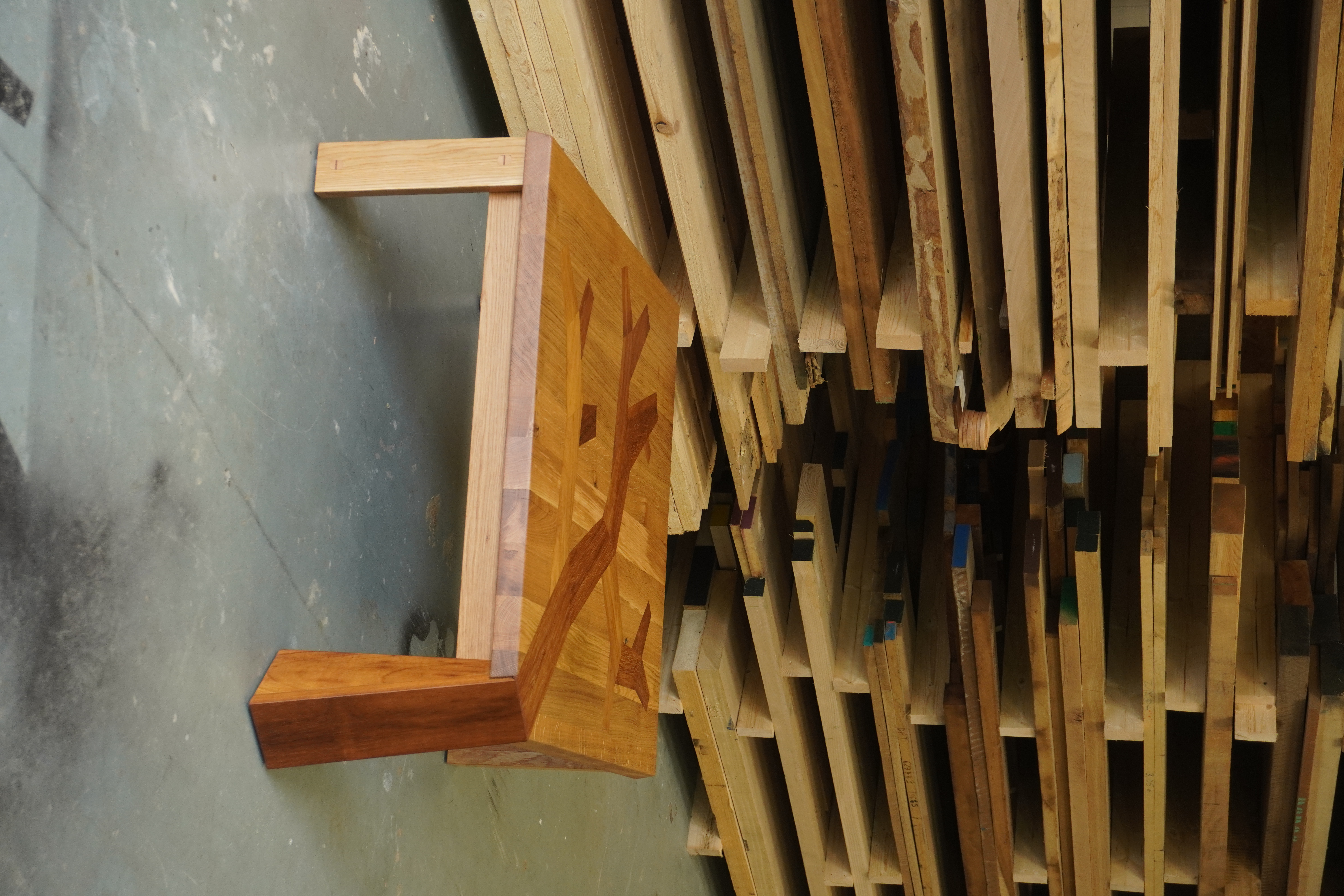 Square coffee table at the workshop surrounded by natural timbers